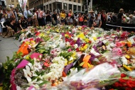 A Sea of Flowers Near Scene; Barrister, Cafe Manager Said to Have Acted Heroically
Visitors lay flowers at a makeshift memorial near the scene of the siege in central Sydney on Tuesday. 