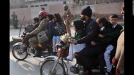 Parents leave with their children after a school in Peshawar, Pakistan, was attacked on Tuesday, December 16. Several members of the Pakistani Taliban stormed the school, killing more than 140 people, mostly children. More than 100 people were injured.