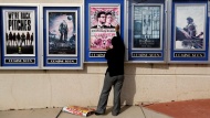 A poster for the movie &quot;The Interview&quot; is taken down from a theater in Atlanta on Wednesday, December 17. Sony Pictures canceled its plans to release the comedy -- which depicts an assassination plot against North Korean leader Kim Jong Un -- following a threat from a group that hacked the movie studio. FBI investigators tracked the hackers back to the North Korean regime, U.S. law enforcement officials said.