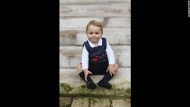 Britain's Prince George sits in a Kensington Palace courtyard in this official Christmas photograph released by his parents, the Duke and Duchess of Cambridge, on Saturday, December 13.