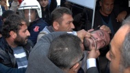 Plain-clothed police officers in Adana, Turkey, detain a man who was trying to set up a tent Monday, December 15, to mourn those killed in Kobani, Syria. Kobani, near the Turkish border, has been devastated by heavy fighting between Kurdish forces and ISIS militants.