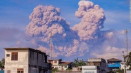 Smoke from the Mount Sinabung volcano is seen from a village on Indonesia's Sumatra island on Sunday, December 14. 