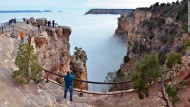 Visitors at Mather Point, on the South Rim of Arizona's Grand Canyon National Park, view a rare weather phenomenon on Thursday, December 11: a sea of thick clouds filling the canyon just below the rim.