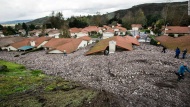 Debris and rocks fill the backyards of homes in Camarillo Springs, California, on Friday, December 12. Ten homes were damaged and ruled uninhabitable after a mudslide crashed into the subdivision and piled rocks almost as high as roof lines, authorities said.